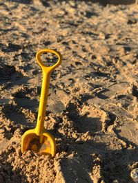 High angle view of yellow toy on beach