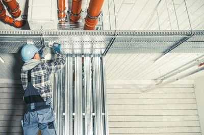 Electrician wearing hardhat working at construction site