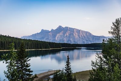 Scenic view of lake by mountains against sky