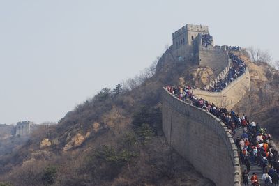 Group of people on fort against the sky