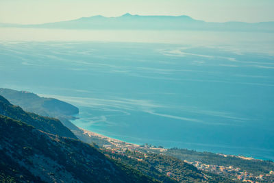 High angle view of sea and mountains against sky