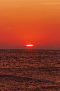 Scenic view of sea against orange sky