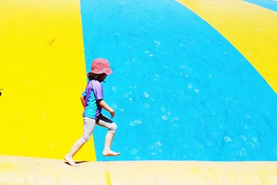 Girl walking on retaining wall