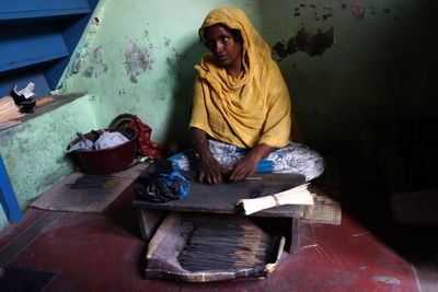 Senior woman sitting on workshop