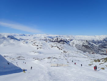 Tourists on snow covered landscape