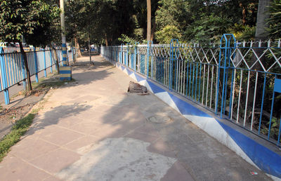 Footpath by swimming pool in park