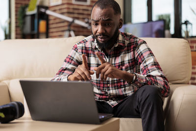 Man using laptop at home