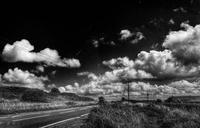 Empty road with mountain range in background