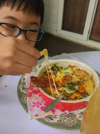 Boy eating food at home