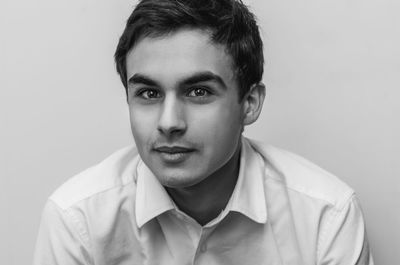 Portrait of young man against white background