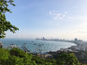 High angle view of city by sea against sky