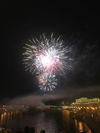 Firework display over city at night