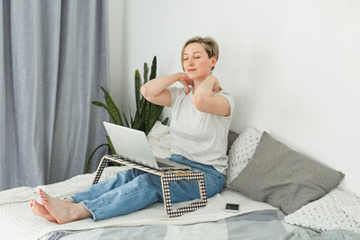 Young woman using laptop at home