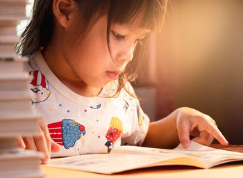 Cute girl reading book