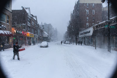 Woman standing on snow covered road