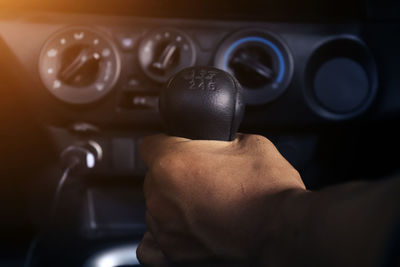 Close-up of man holding cigarette in car