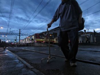 Man standing in city against sky