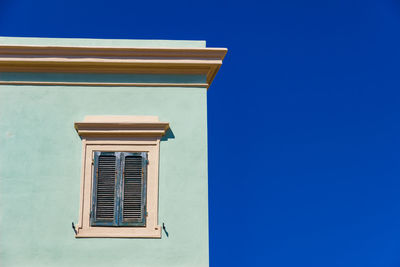 Low angle view of building against blue sky