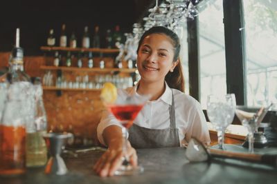 Portrait of smiling friends standing at restaurant