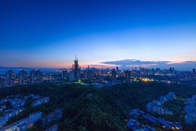 High angle view of city lit up at night