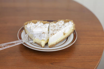 Two slices of lemon meringue pie on plate