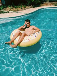 High angle view of young man in swimming pool