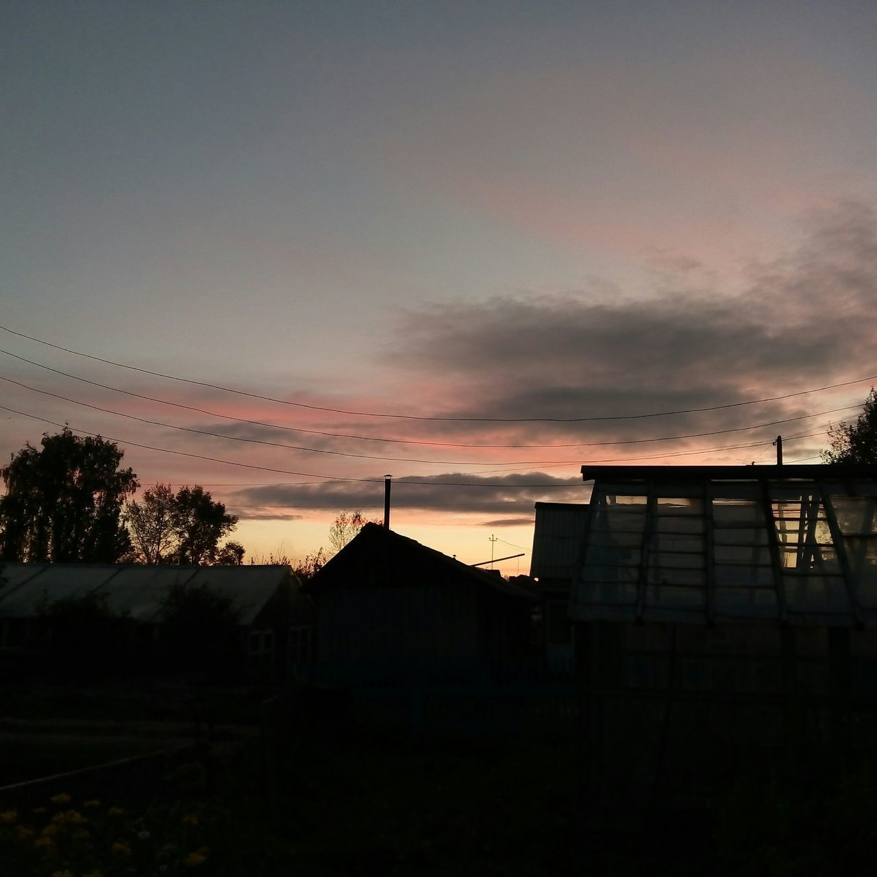 architecture, building exterior, built structure, sunset, silhouette, sky, house, dusk, low angle view, cloud - sky, orange color, residential structure, tree, roof, residential building, outdoors, building, nature, no people, cloud