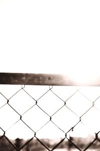 Close-up of chainlink fence against clear sky
