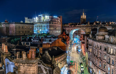 Aerial view of illuminated buildings in city at night