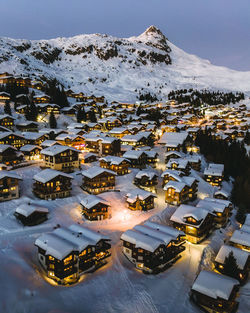 High angle view of snow covered houses and buildings in city