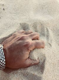 High angle view of man sleeping on sand