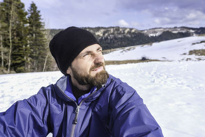 Man sitting on snow field