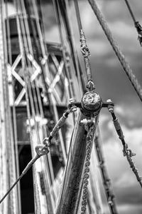 Close-up of rusty metal chain against fence