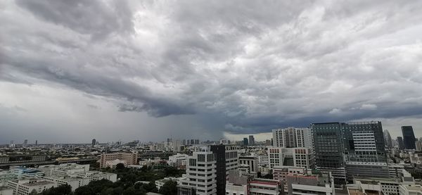 High angle view of buildings against cloudy sky