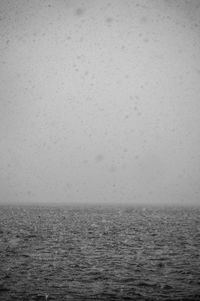 Scenic view of snowy sea against sky