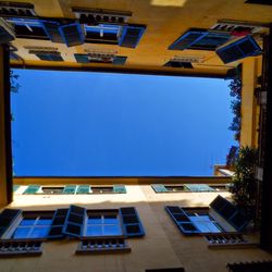 Low angle view of building against blue sky