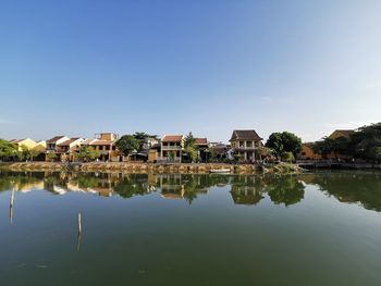 Buildings by lake in city