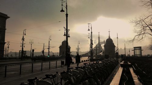 Bicycles parked on street against sky