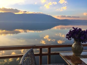 Scenic view of sea against cloudy sky during sunset