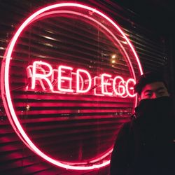 Close-up of illuminated text on road at night