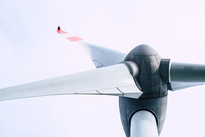 Low angle view of airplane flying against clear sky