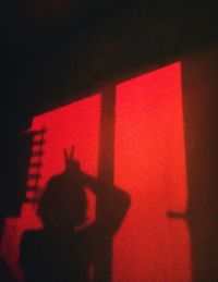 Close-up of hand on illuminated red light