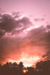 Low angle view of silhouette trees against sky during sunset