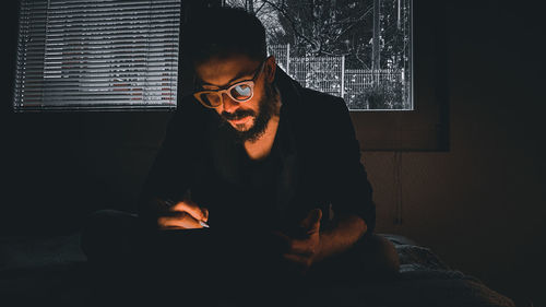 Man sitting by window at home