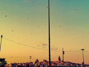 Silhouette of buildings against cloudy sky
