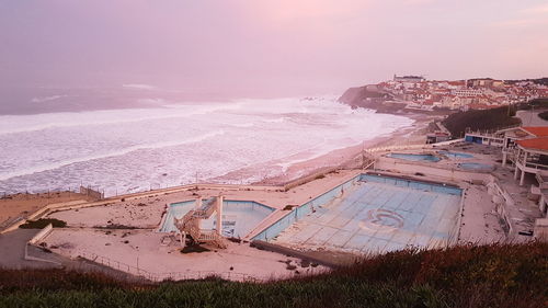High angle view of sea shore against sky during sunset