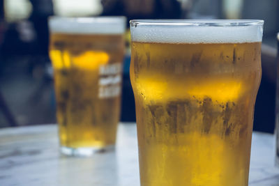 Close-up of beer glass on table