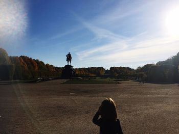 Man and woman standing sculpture against sky