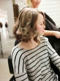 Young woman looking down while standing at camera