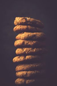 Stack of cookies against black background